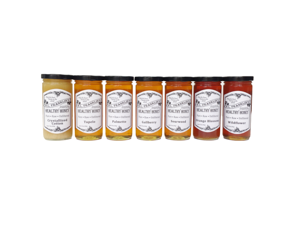 Set of seven assorted condiment jars with white labels.