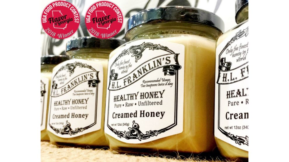 Jars of creamy creamed honey with vintage labels.